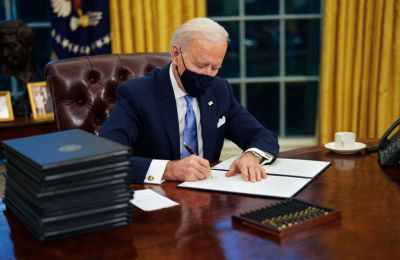 Biden rolls back Trump policies on Day One