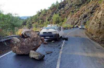 Boulder smashes pickup truck on mountain road