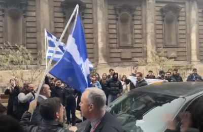 Turkish Cypriot leader cheered by supporters as Greek Cypriot students try to block his car at an event