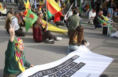 Kurdish protesters march in Nicosia, carrying flags and banners against Turkish attacks in Syria. Photo by Philippos Christou