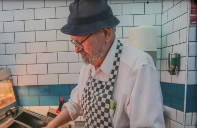 91 and still frying, Mr. Panayis won’t hang up his apron. Photo credit: SWNS Youtube