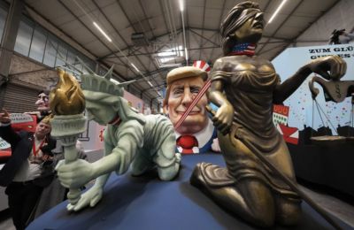 Trump’s new pets: Lady Liberty and Justice now on a short leash. Photo credit: AP/Martin Meissner