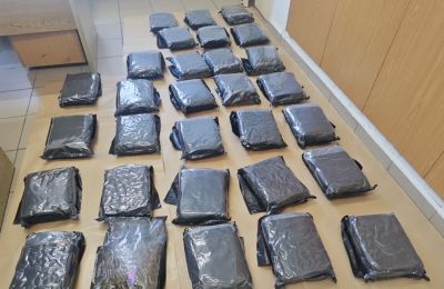 Police say man used false ID to claim international shipment containing 30 sealed drug packages.