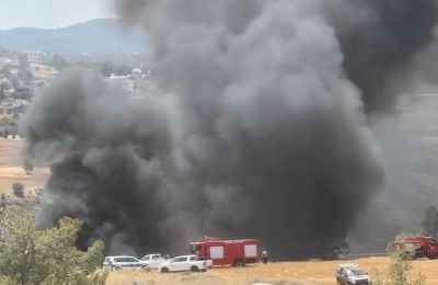 Officials say blaze spread quickly through metal structures; residents treated for minor injuries. Photo screen capture of Giorgos Perikleous Facebook video