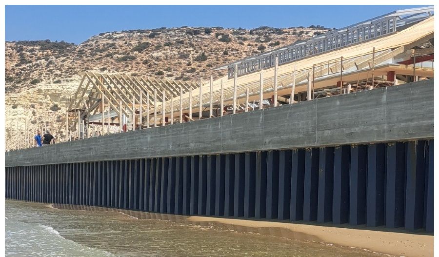 Construction on protected shoreline prompts concerns over legal compliance and environmental governance in British-controlled areas.