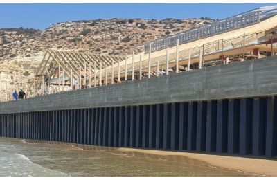 Construction on protected shoreline prompts concerns over legal compliance and environmental governance in British-controlled areas.