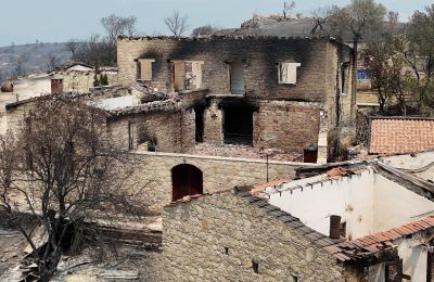 A charred building in the village of Lofou stands as a grim reminder of the destruction caused by the recent forest fires. File photo
