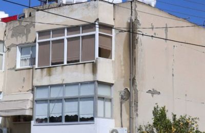 Elderly refugee residents lifted by forklifts to enter and exit their flats