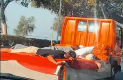 Two people spotted lying on flatbed of moving truck in Limassol