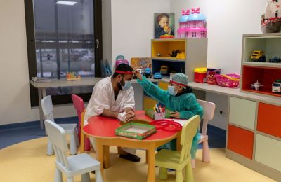 Syrian refugee Yahia Aldarwish, 10, plays a board game with his father Abdulaziz, 32, after a successful kidney transplant with his father as donor. (Stelios Misinas/Reuters)