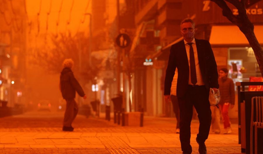 Person walking along a street on the island of Crete with orange dust. Reuters photo.