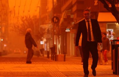 Person walking along a street on the island of Crete with orange dust. Reuters photo.