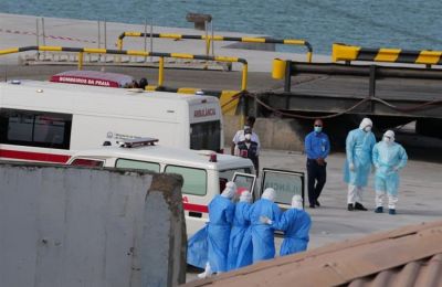Healthcare personnel wearing protective gear transport patients from the MV Hondius cruise ship to the port of Praia, Cape Verde.
