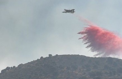 Evacuation orders issued for parts of Agia Anna and Psevdas after the fire spread beyond the military shooting range.